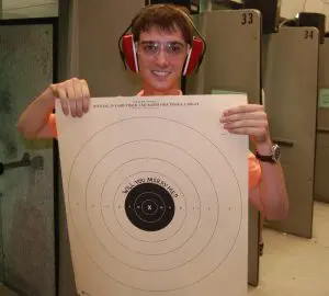 Man holding a Target board propsing