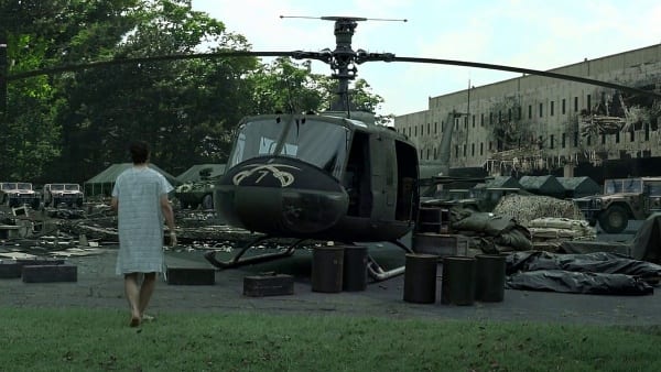 Patient with a gun walks near a helicopter in a Movie Scene 