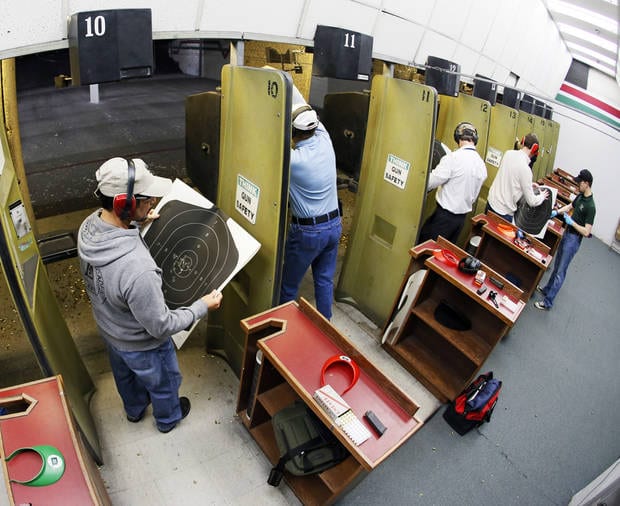 Participants check their targets after firing their handguns on a gun range during a concealed-carry class at H&H Gun Range and Shooting Sports Complex in Oklahoma City, Wednesday, Jan. 23, 2013. Photo by Nate Billings, The Oklahoman