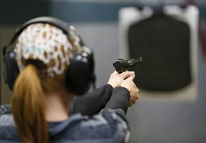 photo - Tracy Lewis takes aim on a gun range Wednesday during a concealed-carry class at H&H Gun Range and Shooting Sports Complex. Photo by Nate Billings, The Oklahoman