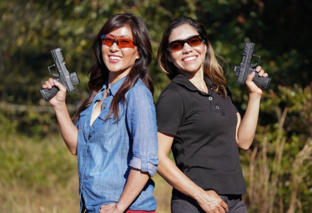 Two Women Confidently Hold Guns While Standing in a Field in Oklahoma City, OK