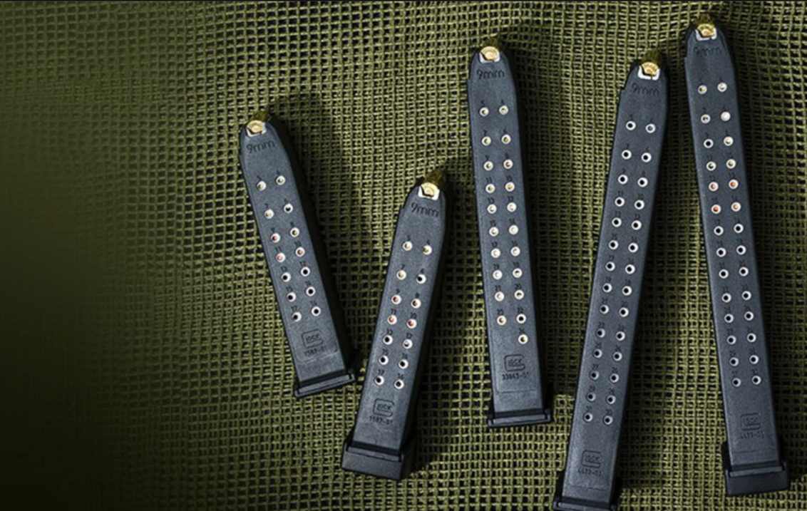 A variety of factory-produced Glock 9mm magazines, featuring different capacities and base plates