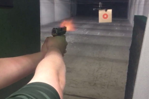 Shooter improving grip strength with handgun training at indoor range